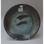 A studio pottery stoneware plate possibly by Bernard Leach, resist decorated with two fish,