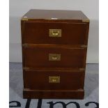 A Campaign style mahogany and brass mounted bedside chest of three drawers, 46cm wide x 63cm high.