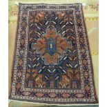An Afshar rug, South Persian, the dark indigo field with a bold stepped madder medallion,
