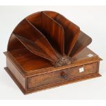 A 19th century mahogany desk tidy, the six division fan shaped top over single frieze drawer,