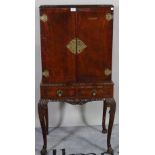 A Victorian style mahogany drinks cabinet over two short drawers on cabriole supports,