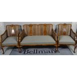 A George II style mahogany framed bergere suite comprising a two seater sofa,