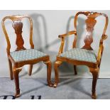 A set of eight 18th century style walnut vase back dining chairs, to include two carvers,