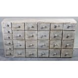 A 20th century blue painted bank of twenty six various drawers,116cm wide x 64cm high.