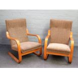 A pair of mid-20th century laminated beech framed open arm easy chairs,