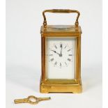 A French brass carriage clock, late 19th century, with visible escapement,