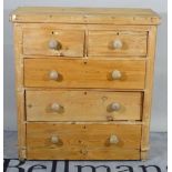 A 20th century pine chest of two short and three long drawers on bun feet, 95cm wide x 103cm high.