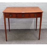 A George III mahogany bowfront side table, with three frieze drawers, on tapering square supports,