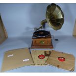 A 20th century gramophone and three records, 35cm wide x 62cm high.