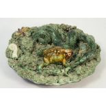 A Palissy style earthenware plate, early 20th century, decorated with applied snake, frog,