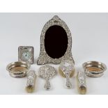 A Victorian silver mounted four piece part dressing set, comprising; a hand mirror,