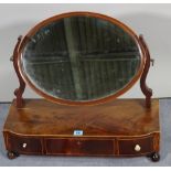 A late Victorian mahogany toilet mirror with three frieze drawers, on bun feet,