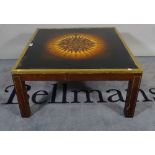 A 20th century mahogany and brass bound square coffee table with inset glass top,