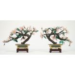 A pair of Chinese hardstone floral bonsai each in a gilt metal rectangular pot on a hardwood stand,