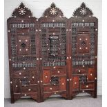 An early 20th century North African mother-of-pearl inlaid hardwood three fold screen,
