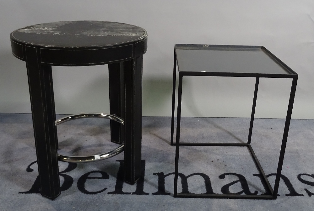 A modern leather upholstered circular occasional table,