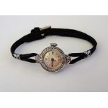 A Bucherer white gold and diamond set lady's dress wristwatch, the signed silvered dial with dot,