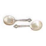 Two similar Georg Jensen silver caddy or preserve spoons,