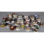 A quantity of early 20th century painted ceramic trinket boxes of various sizes and shapes,