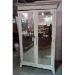A late Victorian white painted single wardrobe with central mirrored door, 135cm wide x 201cm high.