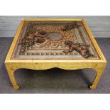 A 20th century coffee table, the square top painted with classical cherubs,