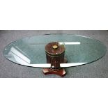 A 20th century coffee table, the oval glass top on reeded column, 168cm wide x 50cm high.