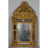 A 19th century gilt brass and bevelled glass cushion shaped wall mirror, 32cm wide x 49cm high.