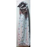 A pair of lined and interlined blue curtains with embroided flower decoration,
