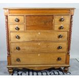 A 19th century Scottish mahogany and oak chest with an arrangement of seven drawers flanked by