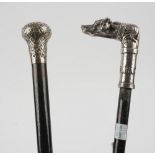 A silver topped ebonised walking cane, with scroll embossed decoration,