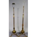 A pair of early 20th century brass standard lamps with outswept supports, 150cm high, (2).