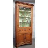 An 18th century oak floor standing corner display cabinet,