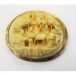 A gold mounted Cantonese carved ivory oval pendant brooch, carved as various figures,
