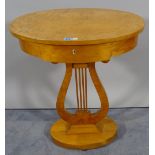 A Biedermeier style satin birch single drawer oval side table on large column plinth base,