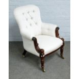 A William IV rosewood framed easy armchair, with bow seat, on lappet carved supports,