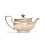 A George III silver teapot, of compressed spherical form, having a decorated rim,