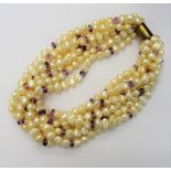 A ten strand baroque pearl and amethyst bead necklace of multi-twist design,