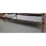 An early Victorian mahogany extending dining table on turned and reeded supports,