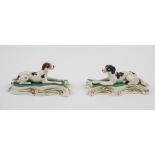 A pair of Staffordshire porcelain figures of a brown and white pointer and a black and white setter,