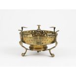 A Dutch 18th century brass brazier stand with pierced sides on three feet, 19.5cm diameter.