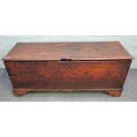 A 17th century elm plank coffer, on bracket feet, 128cm wide x 52cm high.