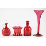 A group of ruby glass, 19th century, comprising; a wrythen moulded mallet shaped decanter, 23cm.