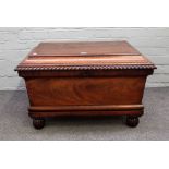 An early 19th century mahogany sarcophagus shaped cellerette, with gadrooned moulding,