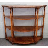 A large 19th century fruitwood Continental serpentine four tier etagere, on turned supports,