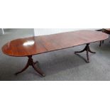A Regency style mahogany 'D' end extending dining table on pair of tripod bases with three extra