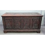 A large 18th century oak coffer, with four panel lid over carved front, 160cm wide x 78cm high.