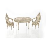 A miniature three piece salon suite, comprising; an oval table and a pair of elbow chairs,