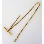 A French gold serpentine link watch Albert chain, fitted with a ridged T bar and with a swivel,