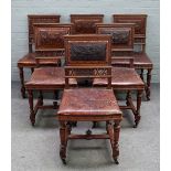 A set of twelve 19th century French walnut dining chairs, with embossed leather square backs,