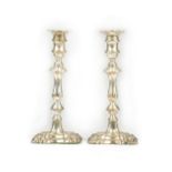 A pair of silver table candlesticks, each with a decorated knopped stem,